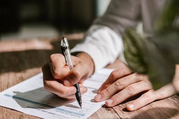 A person integrating a light stretch into their daily office routine, showing work-life balance.