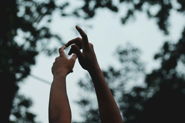 Silhouette of a person performing a natural squatting motion against a stylized background.